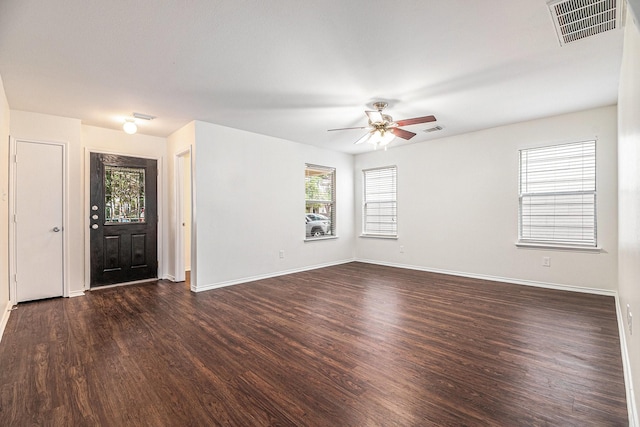 interior space with dark hardwood / wood-style flooring, a wealth of natural light, and ceiling fan