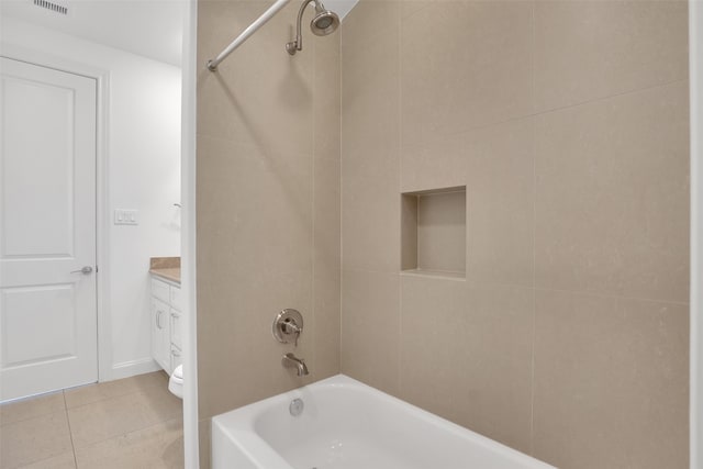 full bathroom featuring tile patterned flooring, vanity, toilet, and tiled shower / bath