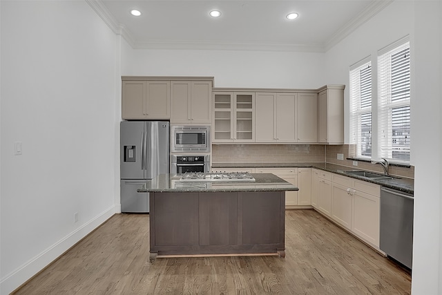 kitchen featuring crown molding, a center island, light wood-type flooring, and appliances with stainless steel finishes