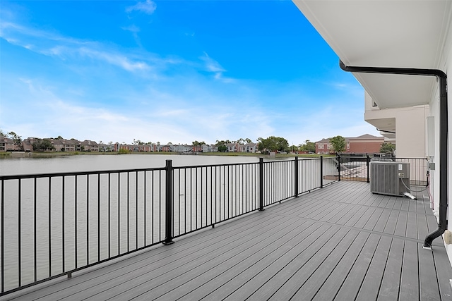 deck with a water view and cooling unit