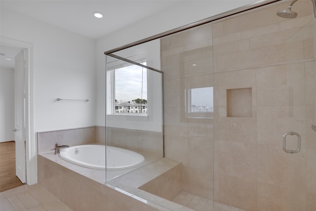 bathroom featuring plus walk in shower and tile patterned flooring