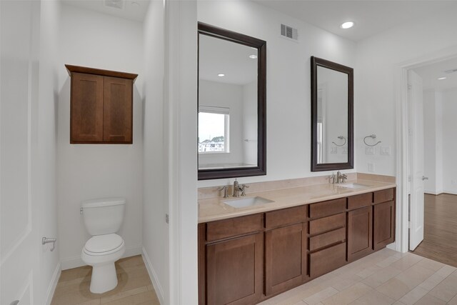 bathroom featuring hardwood / wood-style flooring, vanity, and toilet