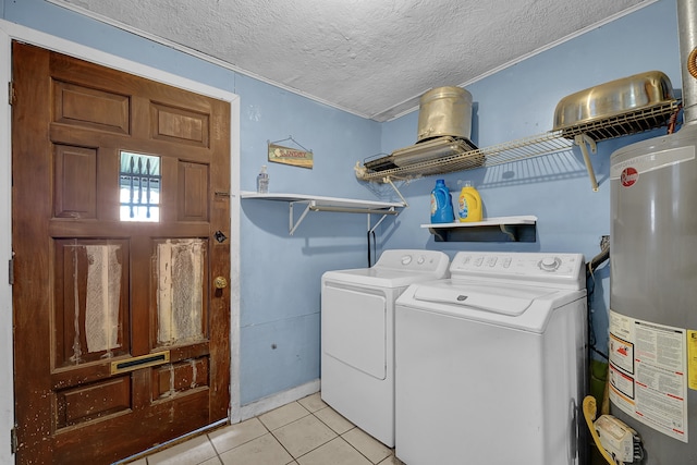 clothes washing area featuring gas water heater, light tile patterned floors, a textured ceiling, and washing machine and dryer