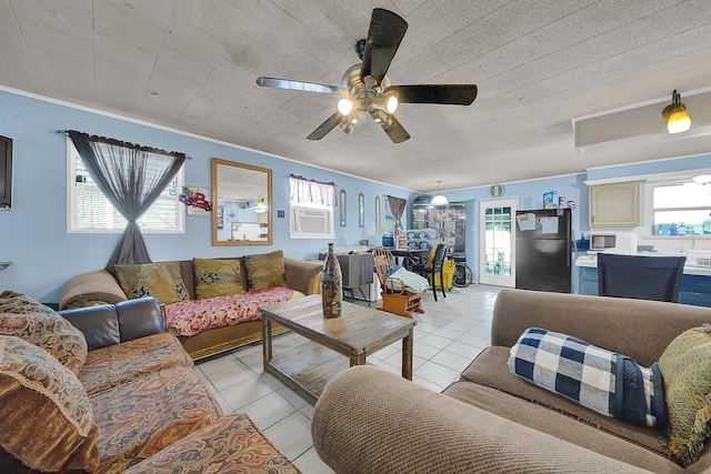 living room featuring light tile patterned floors, ceiling fan, and ornamental molding