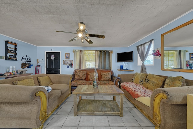 tiled living room with ceiling fan and ornamental molding