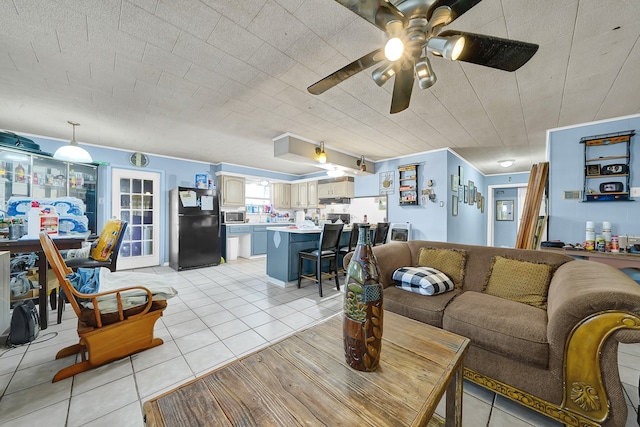 living room with ceiling fan and light tile patterned floors