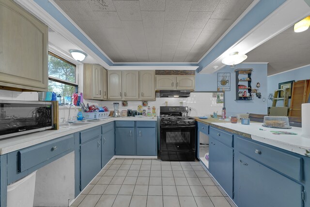 kitchen with light tile patterned flooring, black range with gas stovetop, ornamental molding, and tasteful backsplash