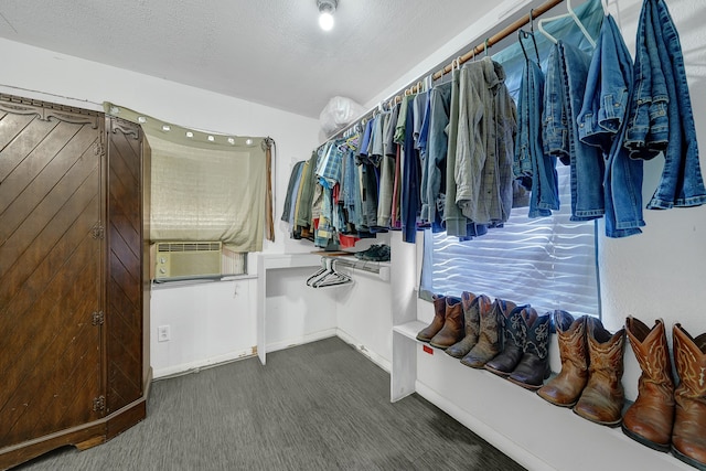 spacious closet featuring dark carpet and cooling unit