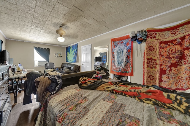 bedroom featuring ceiling fan and crown molding