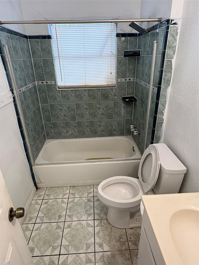 bathroom with vanity, a textured wall, tub / shower combination, and toilet