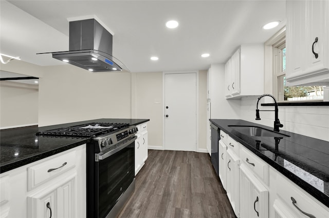 kitchen featuring white cabinetry, sink, stainless steel gas range, dark hardwood / wood-style flooring, and island range hood