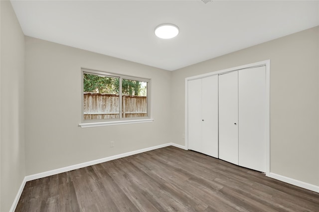 unfurnished bedroom featuring a closet and wood-type flooring