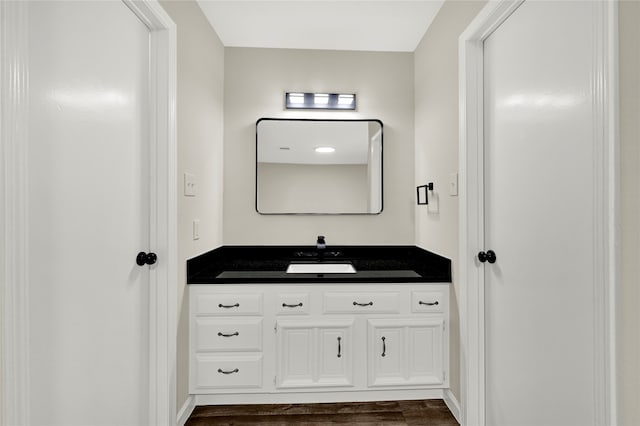 bathroom with vanity and wood-type flooring