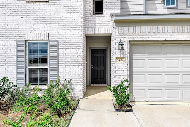 view of exterior entry with a garage