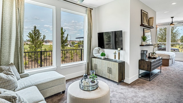 living room with ceiling fan, a healthy amount of sunlight, and carpet floors