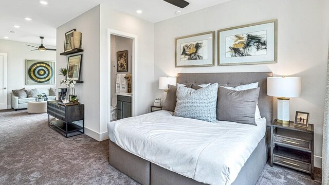 carpeted bedroom with ensuite bath and ceiling fan