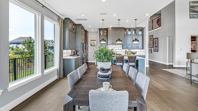 dining space with hardwood / wood-style floors and a wealth of natural light