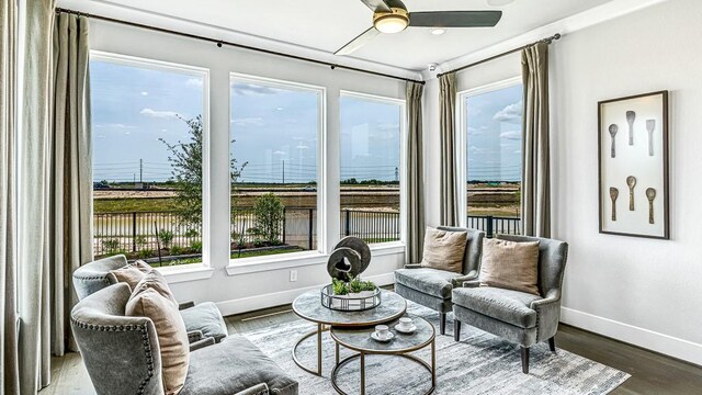 sunroom featuring ceiling fan