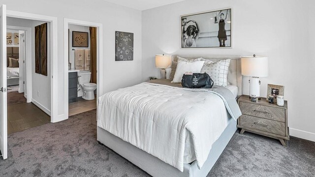 bedroom with dark colored carpet and ensuite bath