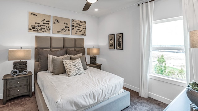 bedroom featuring dark carpet and ceiling fan