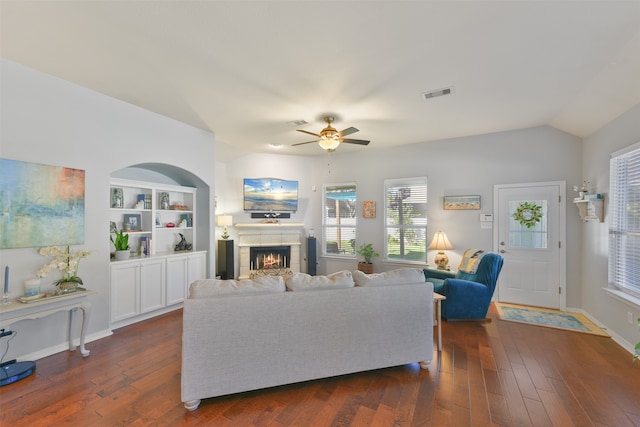 living room with ceiling fan, dark hardwood / wood-style flooring, and vaulted ceiling