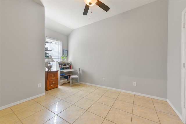 unfurnished office featuring ceiling fan, light tile patterned floors, and vaulted ceiling