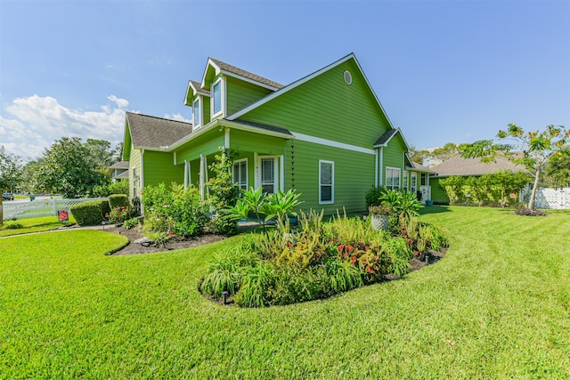 view of side of property with a yard