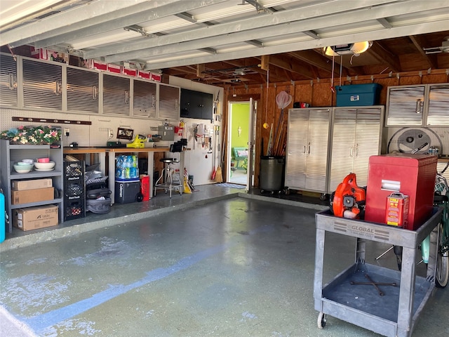 garage with a workshop area and a garage door opener