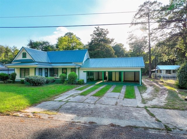 view of front facade with a carport and a front lawn