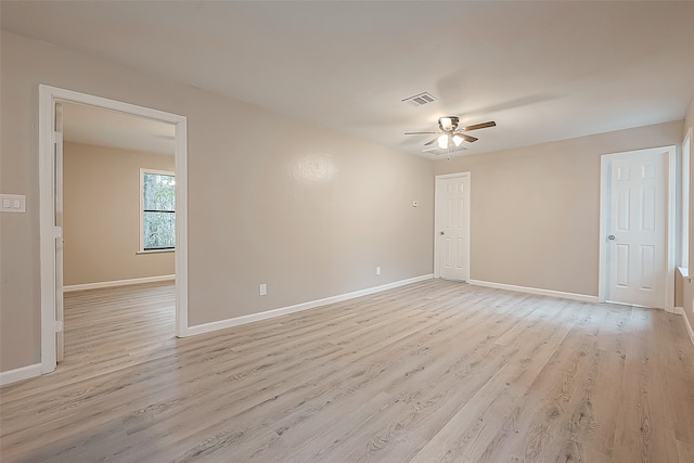 empty room featuring ceiling fan and light wood-type flooring