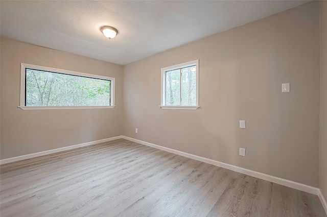 empty room with light hardwood / wood-style flooring