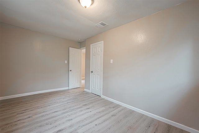 unfurnished room with light hardwood / wood-style floors