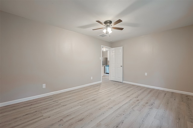 spare room with ceiling fan and light wood-type flooring