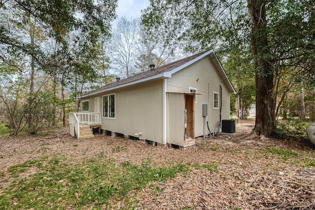 view of side of property with central air condition unit