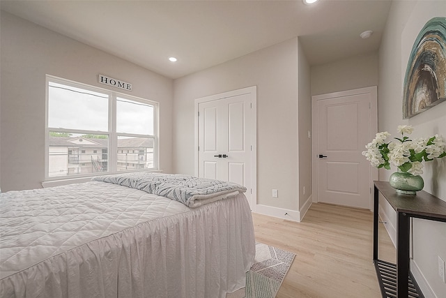 bedroom featuring a closet and light wood-type flooring