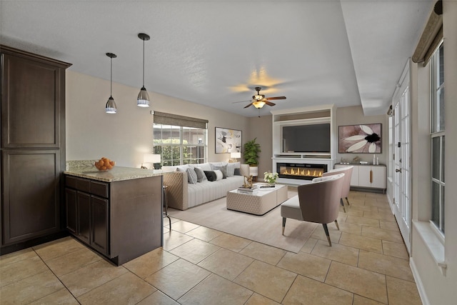 tiled living room with ceiling fan