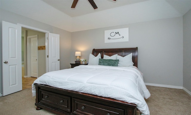 bedroom with ceiling fan and light colored carpet