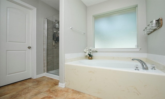 bathroom with separate shower and tub and tile patterned floors