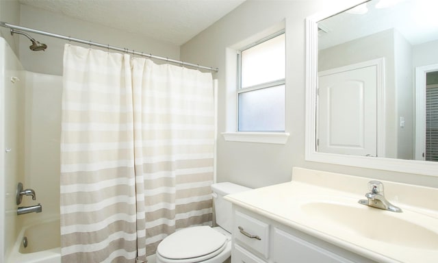 full bathroom featuring vanity, a textured ceiling, shower / bath combo, and toilet