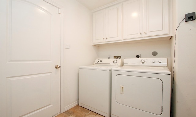 laundry room featuring separate washer and dryer and cabinets