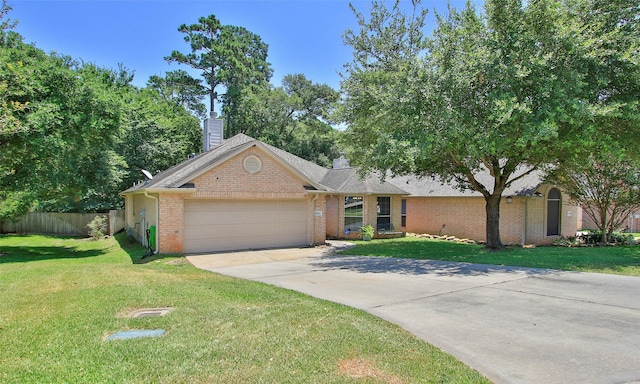 ranch-style house featuring a garage and a front lawn