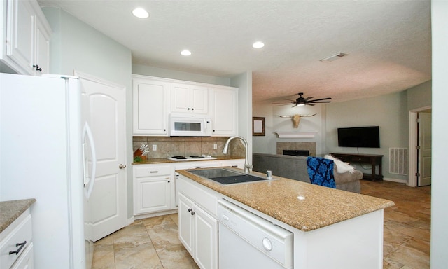 kitchen with white cabinetry, an island with sink, sink, ceiling fan, and white appliances