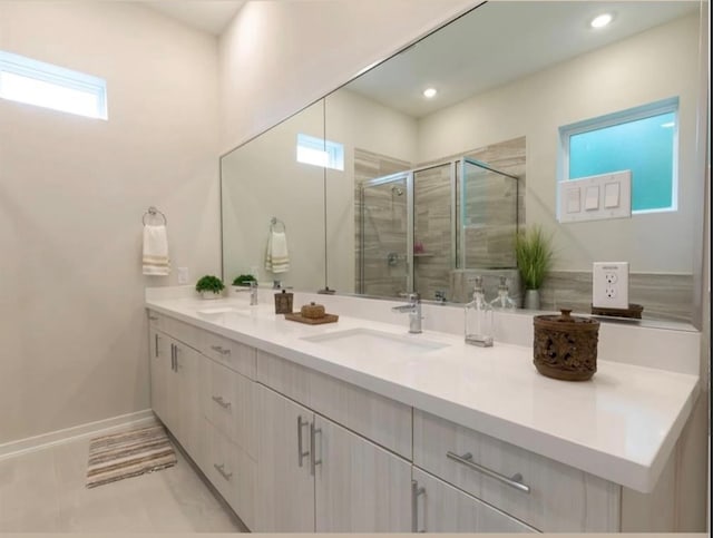 bathroom featuring tile patterned floors, vanity, and a shower with shower door