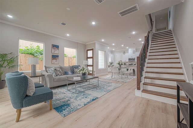 3837 Mainer St, Houston, TX 77021 - living room with light hardwood / wood-style floors and ornamental molding