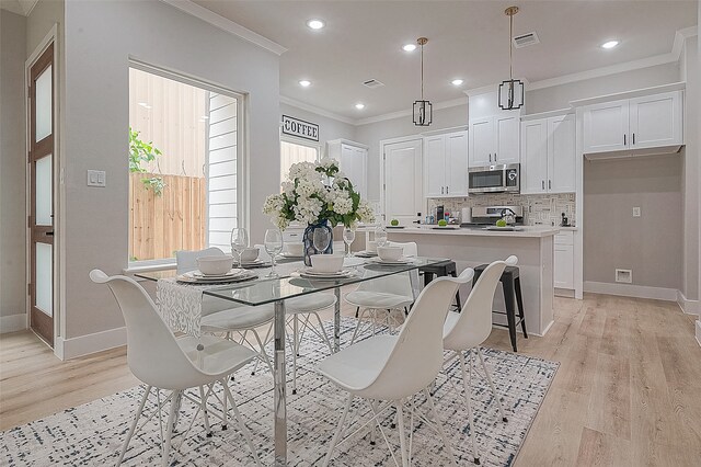 3837 Mainer St, Houston, TX 77021 - dining room featuring light wood-type flooring and crown molding