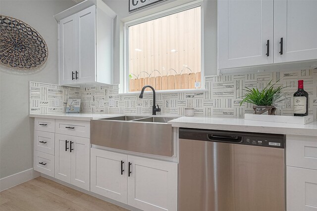 3837 Mainer St, Houston, TX 77021 - kitchen featuring white cabinetry, decorative backsplash, dishwasher, and sink