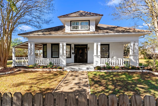 view of front of property with a front yard and a porch