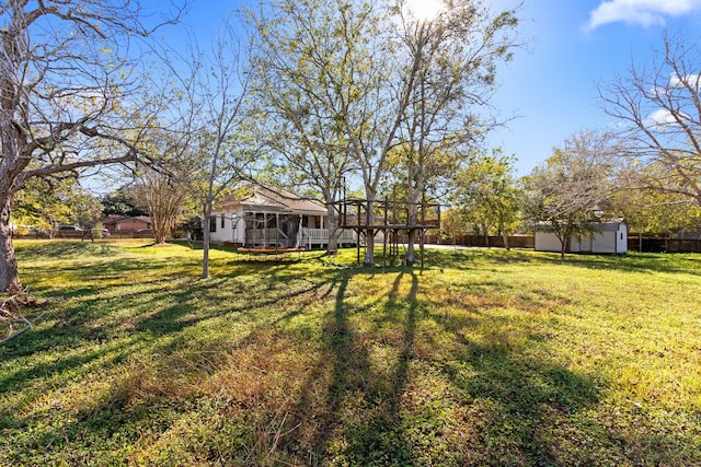 view of yard with a sunroom and a wooden deck