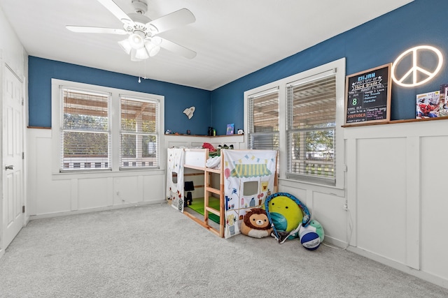 carpeted bedroom featuring ceiling fan and multiple windows