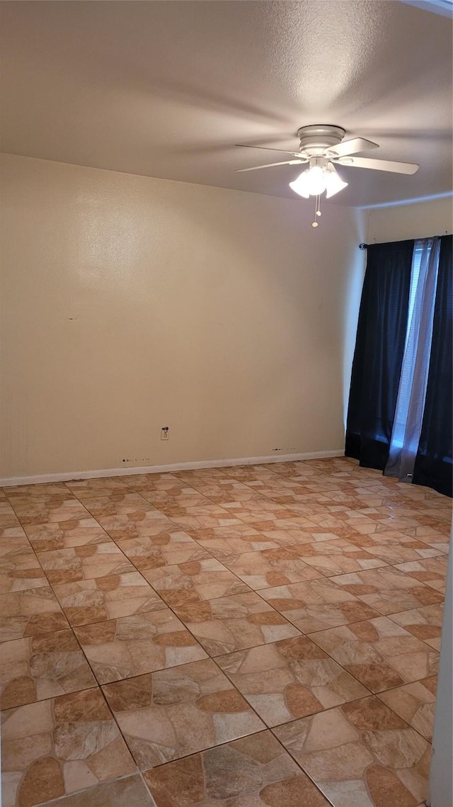 spare room featuring ceiling fan